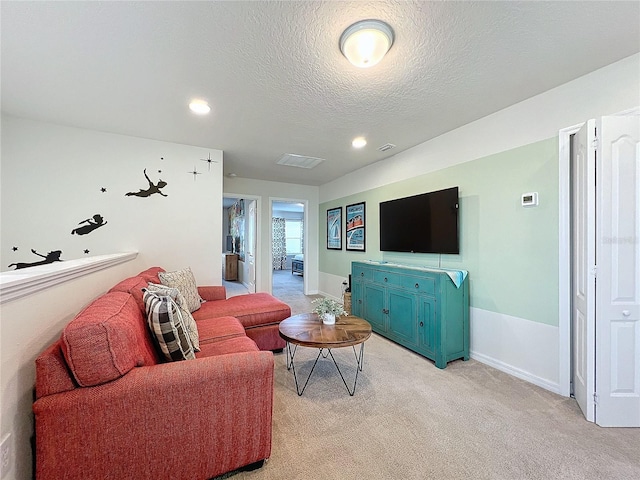 living room featuring a textured ceiling and light colored carpet