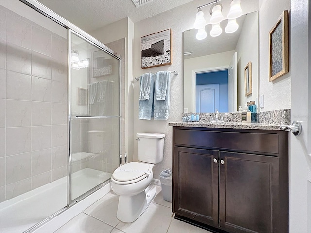 bathroom with a textured ceiling, toilet, vanity, an enclosed shower, and tile patterned floors