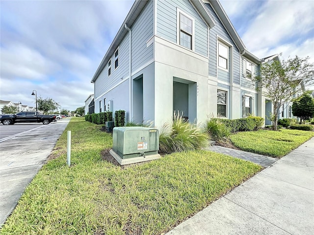 view of property exterior with a lawn