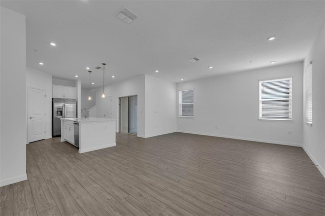 unfurnished living room featuring light hardwood / wood-style floors