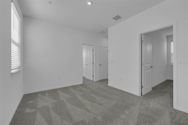 unfurnished bedroom with light carpet