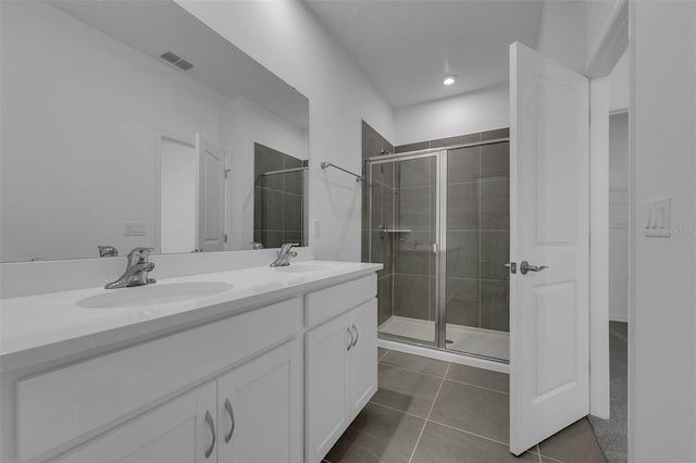 bathroom with vanity, a shower with shower door, and tile patterned flooring