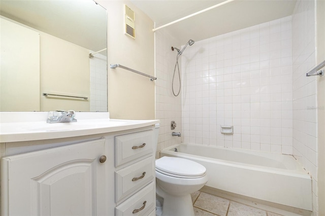 full bathroom featuring tiled shower / bath combo, vanity, tile patterned floors, and toilet