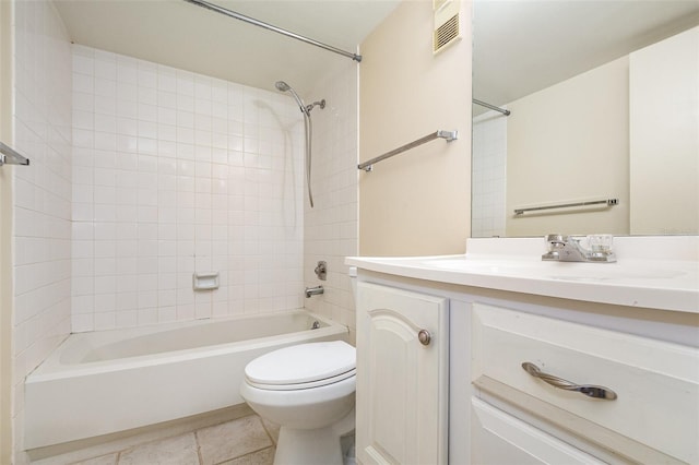 full bathroom featuring tiled shower / bath combo, vanity, tile patterned floors, and toilet