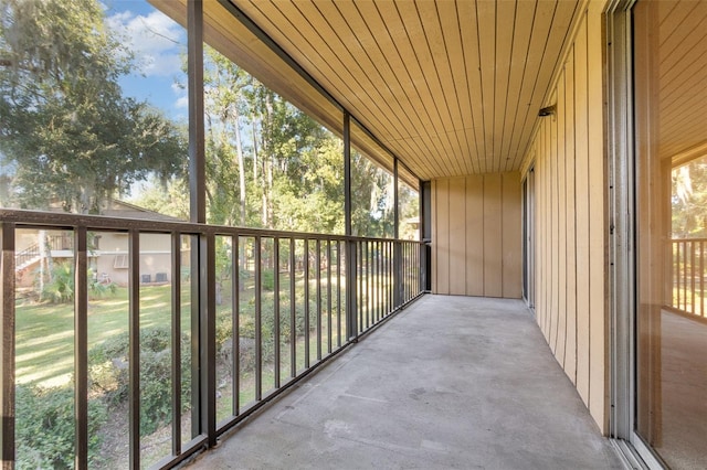 unfurnished sunroom with wood ceiling