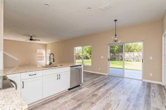 kitchen with sink, decorative light fixtures, stainless steel dishwasher, white cabinets, and light hardwood / wood-style flooring