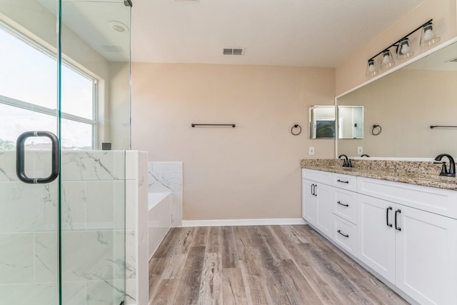 bathroom featuring vanity, hardwood / wood-style floors, and separate shower and tub