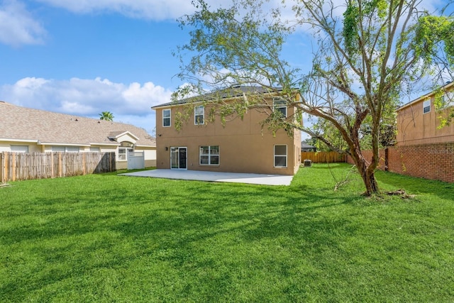 rear view of house with a patio and a yard