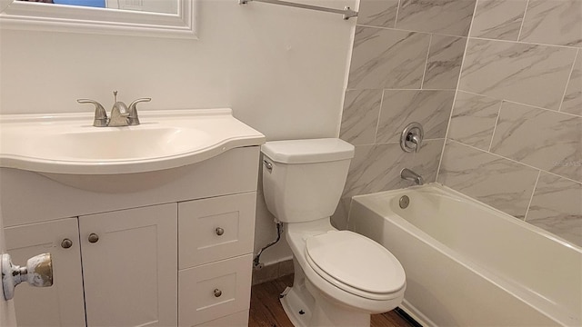 full bathroom with vanity, toilet, hardwood / wood-style flooring, and tiled shower / bath