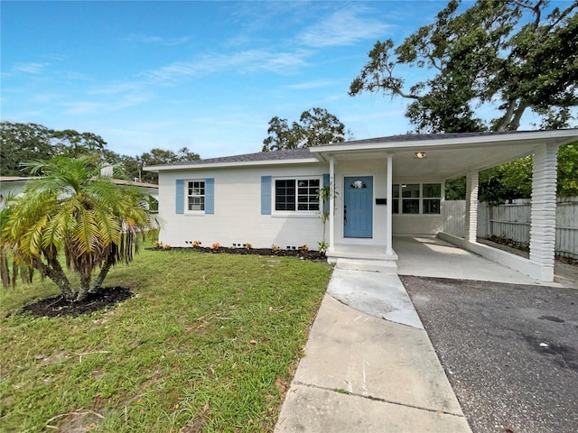 view of front facade featuring a front yard and a carport