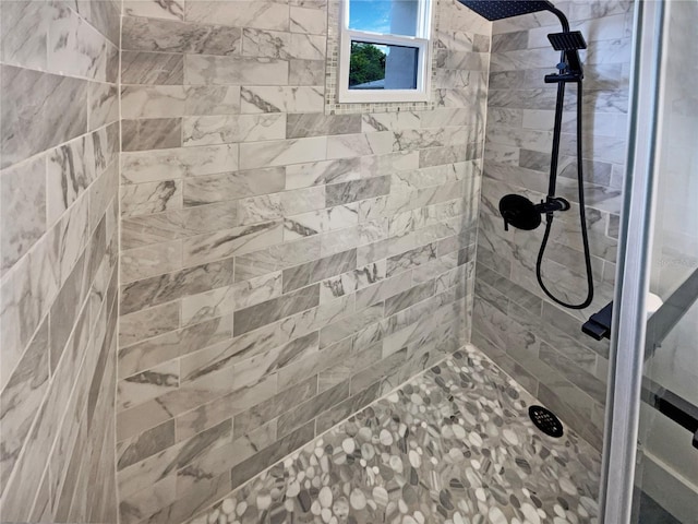 bathroom with tiled shower