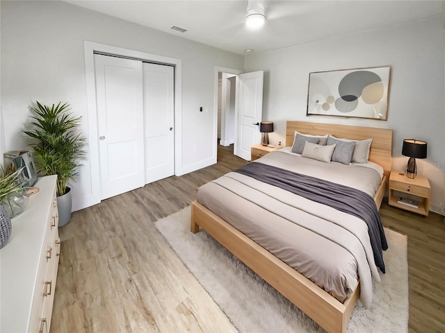 bedroom featuring hardwood / wood-style flooring, a closet, and ceiling fan