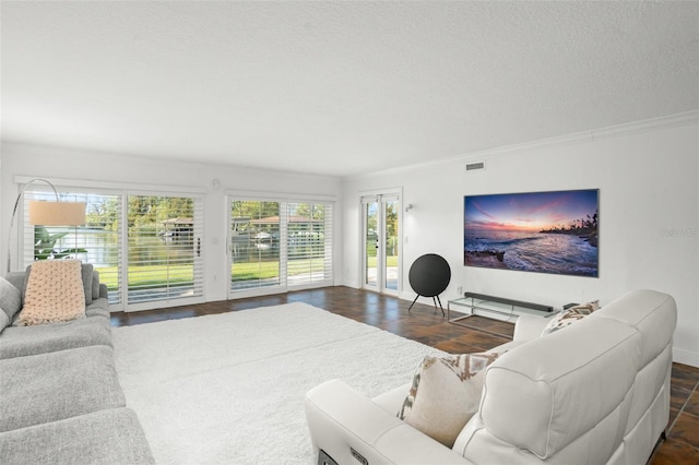 living room with ornamental molding and a textured ceiling