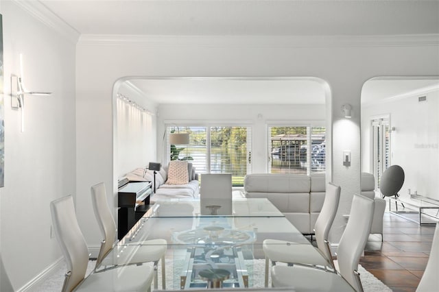 tiled dining area featuring crown molding