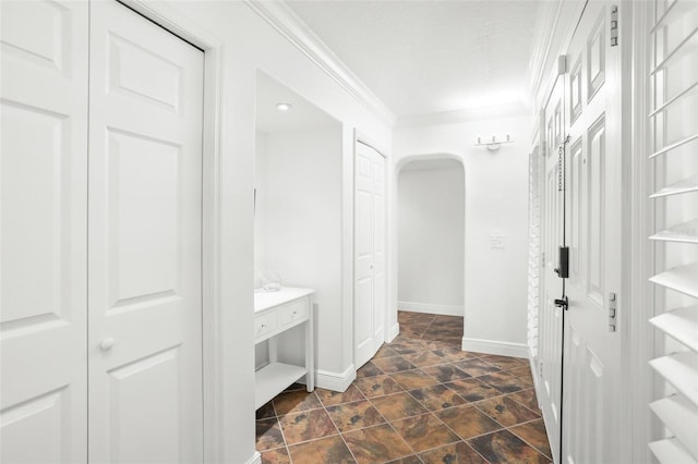 8984 Houston Pl Unit 103, Orlando, FL 32819 - mudroom featuring ornamental molding, arched walkways, and dark stone finish floors
