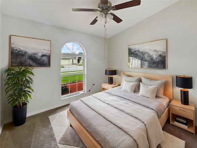 bedroom with dark carpet, lofted ceiling, and ceiling fan