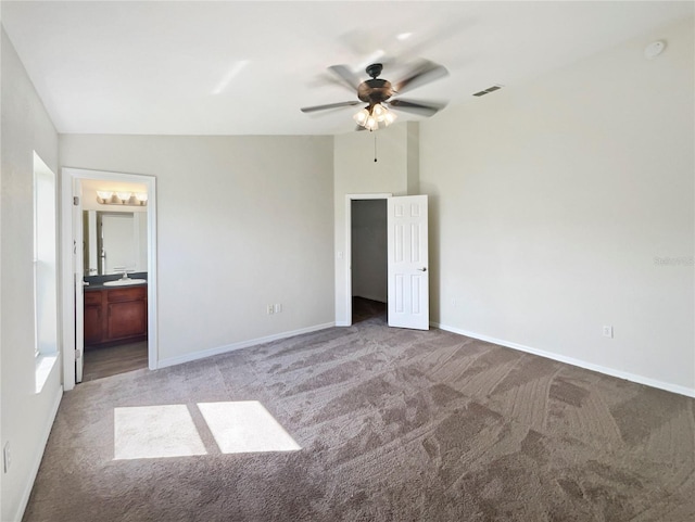 unfurnished bedroom featuring connected bathroom, ceiling fan, vaulted ceiling, and light colored carpet