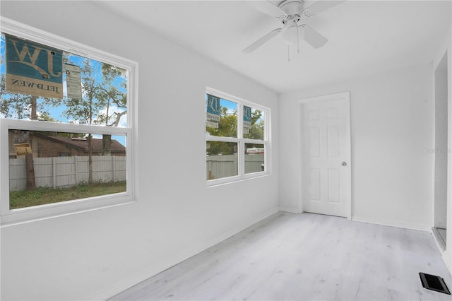 unfurnished room featuring light wood-type flooring and ceiling fan