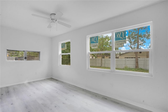 spare room featuring light hardwood / wood-style floors and ceiling fan