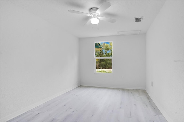 spare room with light hardwood / wood-style flooring and ceiling fan