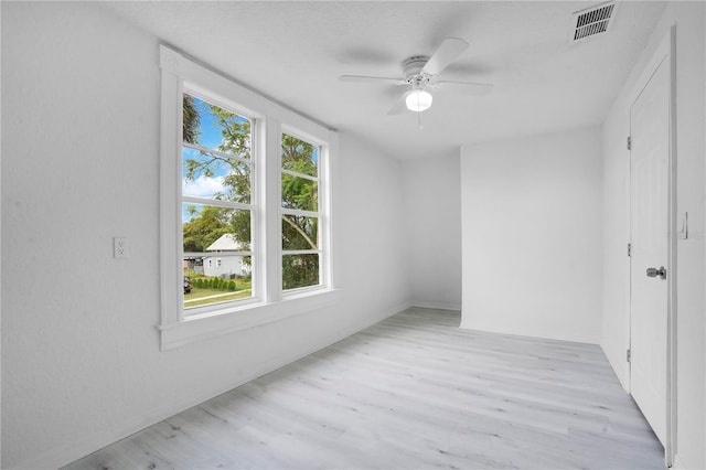 spare room featuring light hardwood / wood-style flooring and ceiling fan