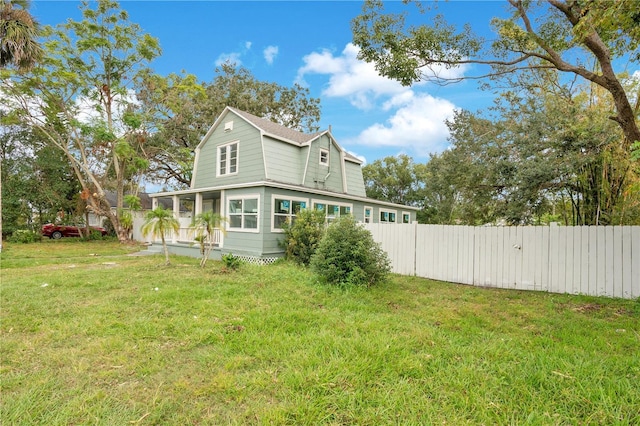 rear view of house featuring a yard