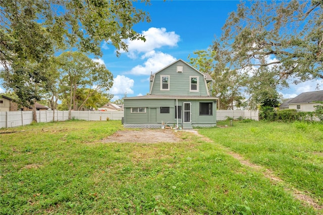 back of house featuring a yard