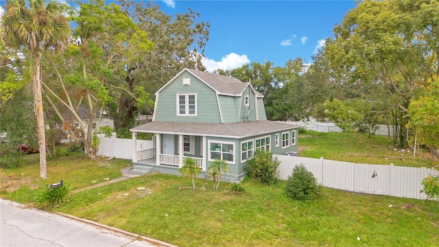 view of front of home with a porch and a front lawn