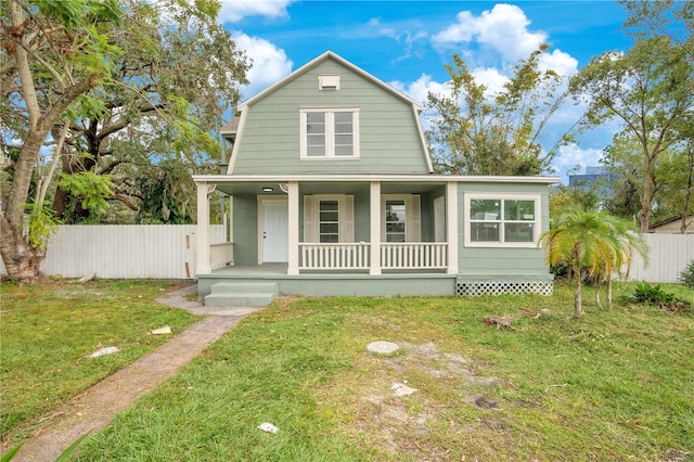 view of front of house featuring covered porch and a front lawn