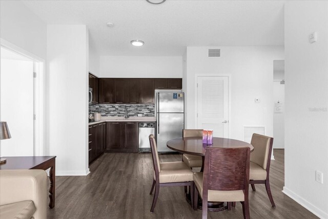 dining area with sink and dark hardwood / wood-style floors