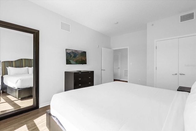 bedroom featuring hardwood / wood-style floors and a closet