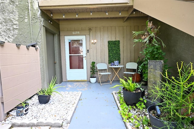 view of exterior entry featuring a patio area