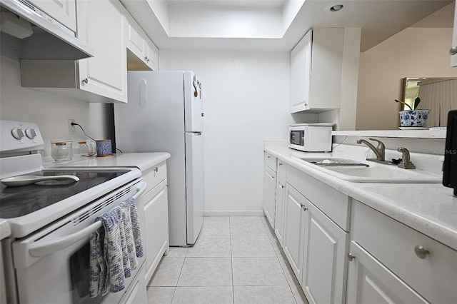 kitchen featuring white cabinetry, sink, light tile patterned floors, and white appliances