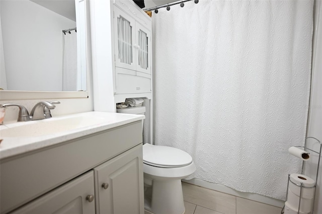 bathroom featuring vanity, toilet, tile patterned floors, and a shower with shower curtain