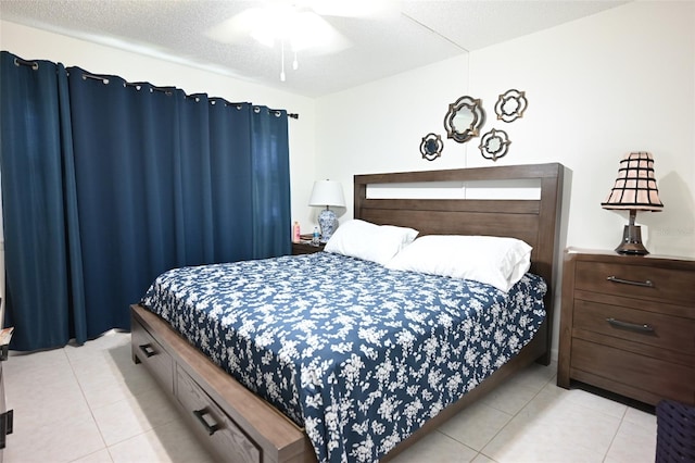 bedroom featuring ceiling fan, a textured ceiling, and light tile patterned flooring