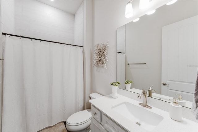 bathroom featuring vanity, toilet, and curtained shower