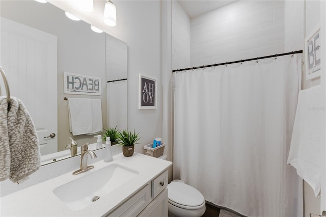 bathroom featuring vanity, a shower with shower curtain, and toilet