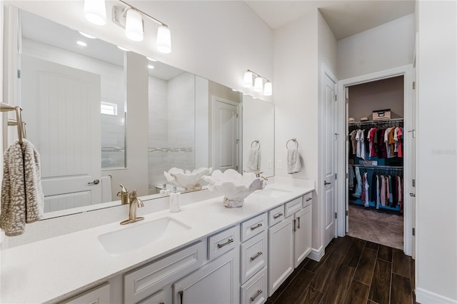 bathroom featuring vanity, hardwood / wood-style floors, and a shower