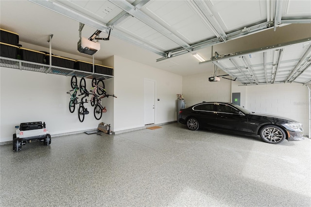 garage with a garage door opener and electric panel