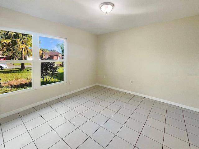 spare room featuring light tile patterned floors