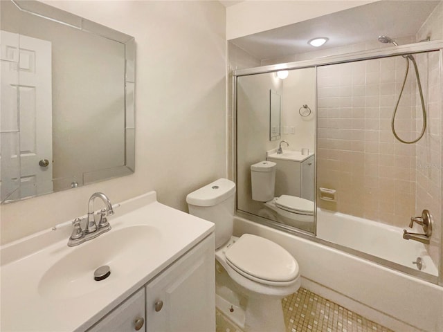 full bathroom featuring vanity, combined bath / shower with glass door, toilet, and tile patterned floors