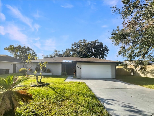 ranch-style home featuring a front yard and a garage