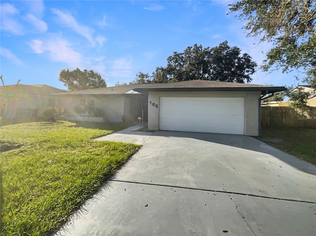 single story home featuring a front yard and a garage