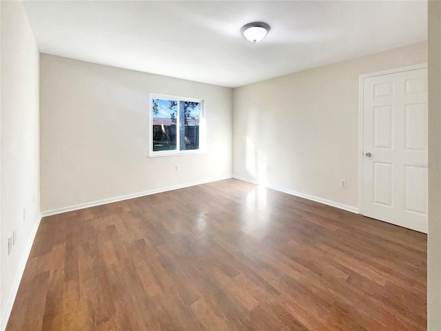 empty room with dark hardwood / wood-style floors