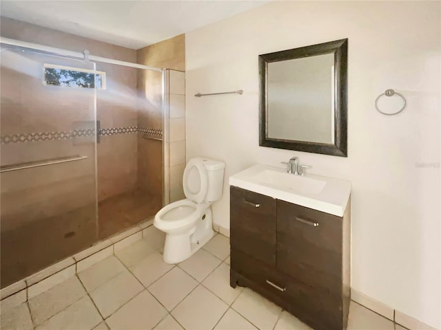 bathroom featuring vanity, tile patterned floors, toilet, and an enclosed shower