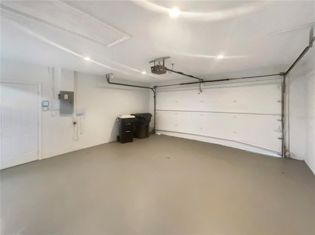 garage featuring a garage door opener and electric panel