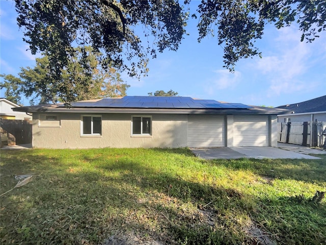 view of side of home with a patio area, a lawn, and solar panels