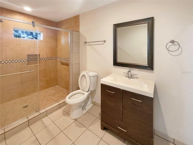 bathroom with vanity, tile patterned floors, toilet, and an enclosed shower