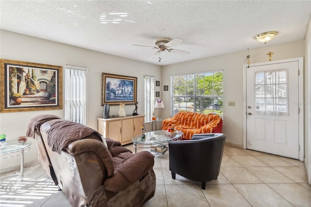 tiled living room featuring ceiling fan and a textured ceiling