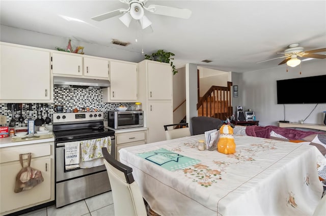 kitchen featuring appliances with stainless steel finishes, tasteful backsplash, light tile patterned floors, and ceiling fan